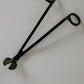 Black metal tool on a light gray background