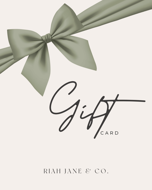 A minimalist gift card design with a large sage green ribbon bow across the top and the words 'Gift CARD' in black script, with 'RIAH JANE & CO.' printed at the bottom on a warm off-white background.