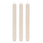 Three beige candles on a white background