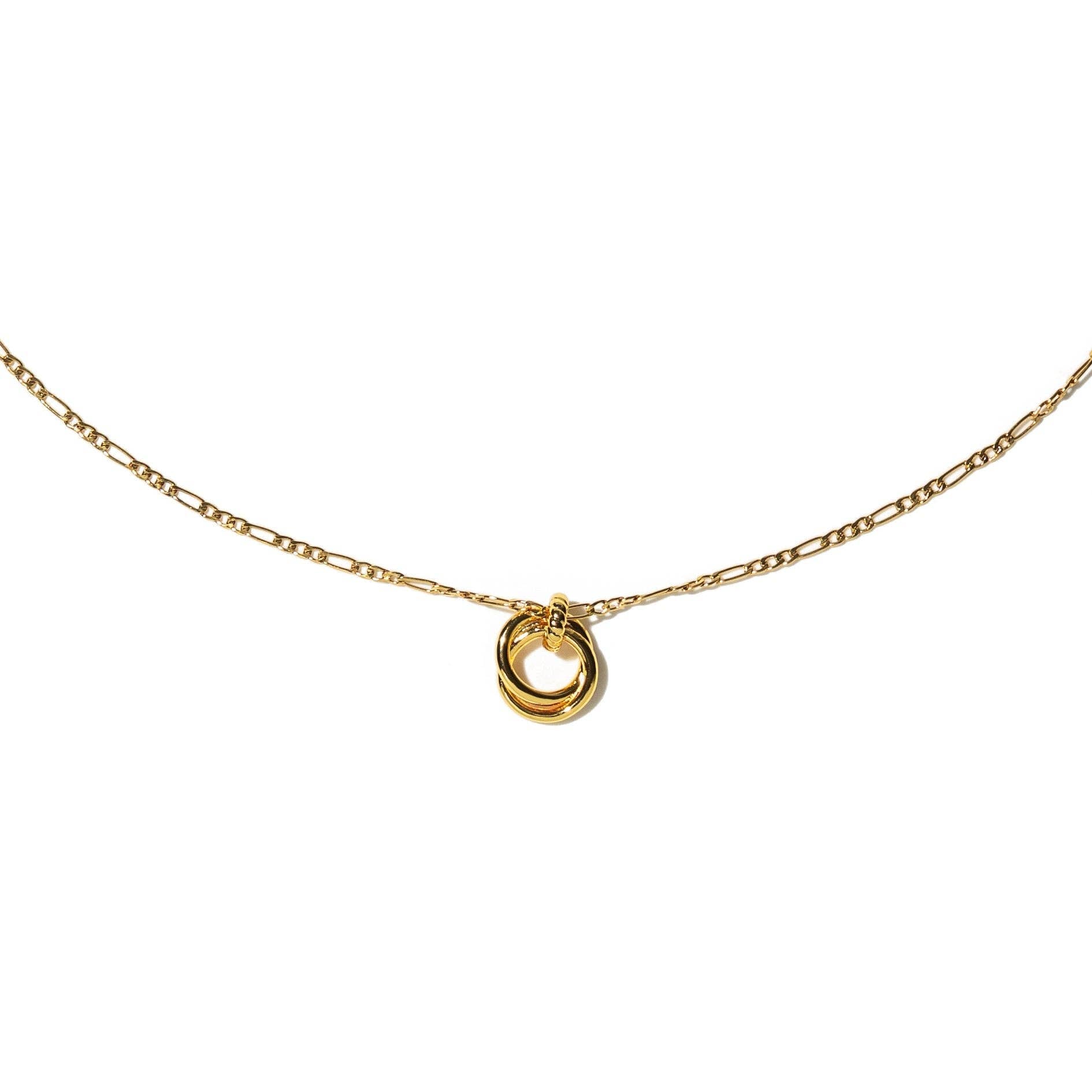 Gold necklace with a small round pendant on a white background