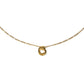 Gold necklace with a small round pendant on a white background